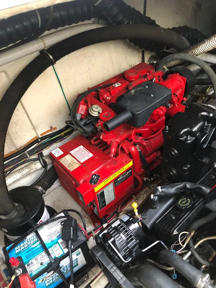 Slide: The Image of Engine compartment of a 2002 Maxum 3300 SCR boat, featuring a red engine. - 22
