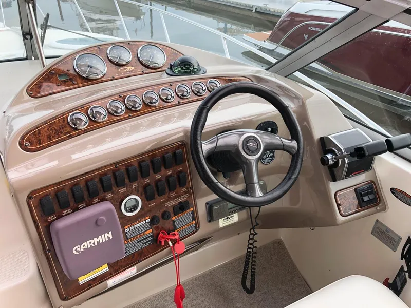 Slide: The Image of 2002 Maxum 3300 SCR boat dashboard with Garmin GPS and steering wheel. - 8