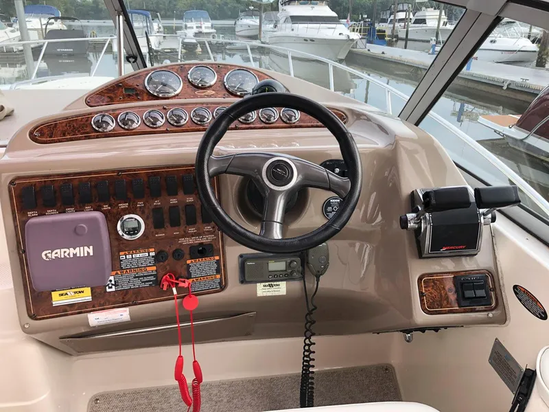 Slide: The Image of 2002 Maxum 3300 SCR boat helm with Garmin navigation system and control panel. - 9