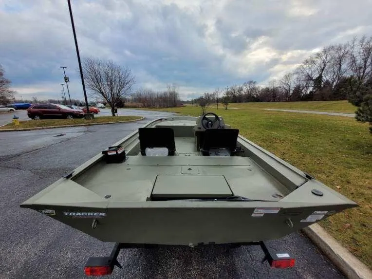 Slide: The Image of 2024 Tracker Grizzly 1754 SC boat on a trailer in a parking lot. - 2
