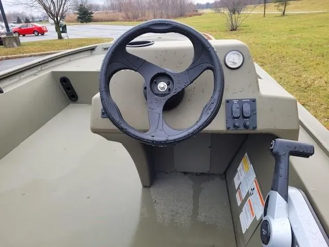 Slide: The Image of 2024 Tracker Grizzly 1754 SC boat steering console with controls and gauge. - 3