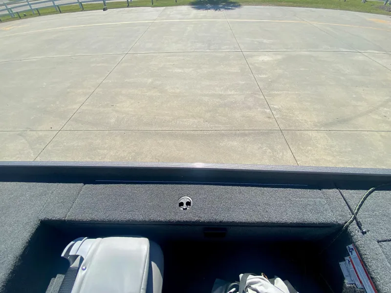 Slide: The Image of 2023 Crestliner 1600 Storm boat interior with gray seating and storage compartments. - 18