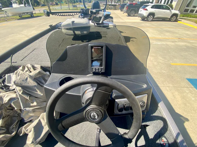 Slide: The Image of 2023 Crestliner 1600 Storm boat dashboard with steering wheel and navigation system. - 8