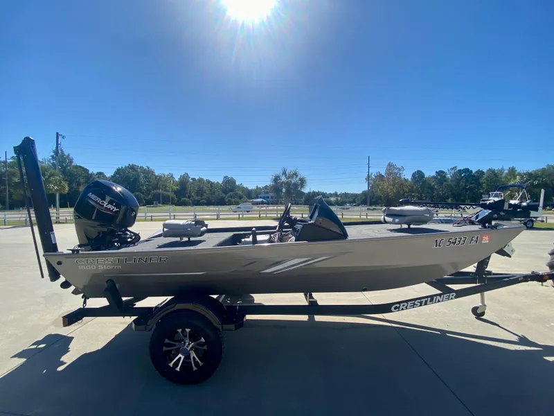 Slide: The Image of 2023 Crestliner 1600 Storm fishing boat on trailer under clear blue sky. - 2