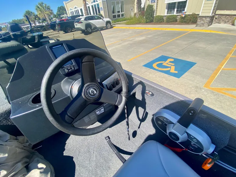 Slide: The Image of 2023 Crestliner 1600 Storm boat dashboard and steering wheel in parking lot. - 9