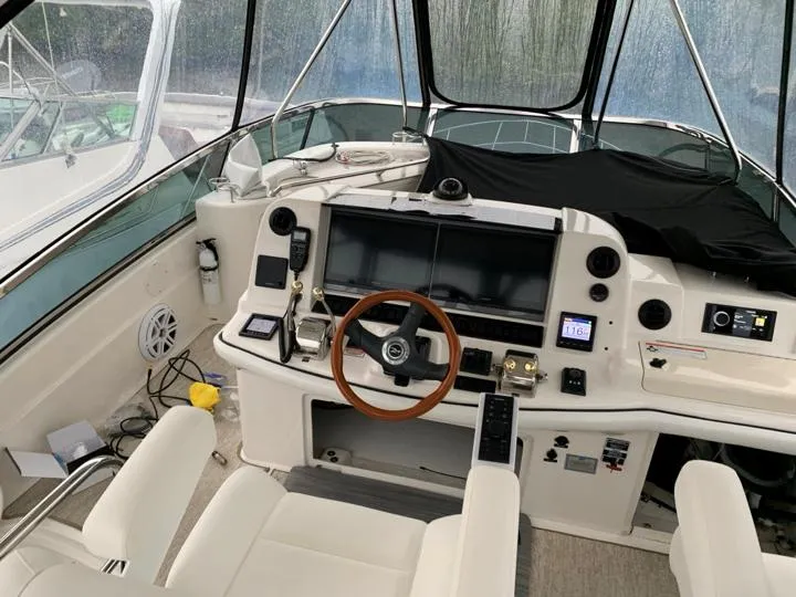Slide: The Image of 2006 Sea Ray 52 Sedan Bridge helm with modern navigation equipment and leather seating. - 10