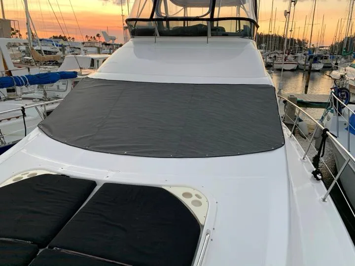 Slide: The Image of 2006 Sea Ray 52 Sedan Bridge yacht docked at sunset. - 11