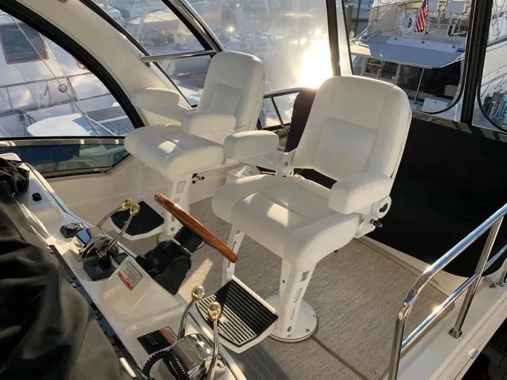 Slide: The Image of 2006 Sea Ray 52 Sedan Bridge helm with dual captain's chairs and control panel. - 12