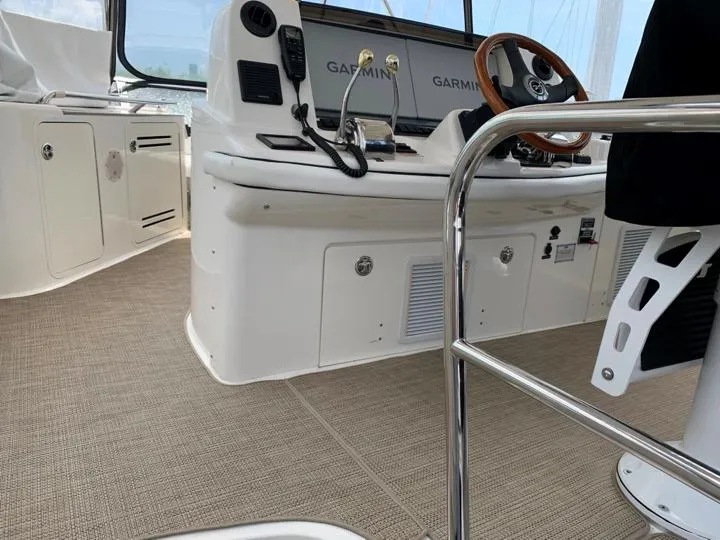 Slide: The Image of 2006 Sea Ray 52 Sedan Bridge helm with Garmin navigation and beige carpet. - 4