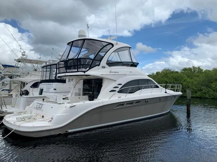 Slide: The Image of 2006 Sea Ray 52 Sedan Bridge yacht docked in a marina. - 6