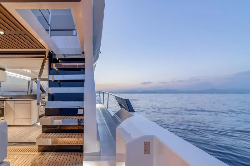 Slide: The Image of 2024 Astondoa AS5 yacht deck at sunset with ocean view. - 12