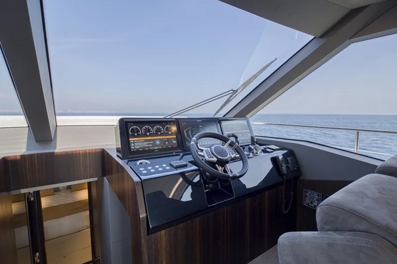 Slide: The Image of 2024 Astondoa AS5 yacht helm station with modern navigation controls and ocean view. - 15