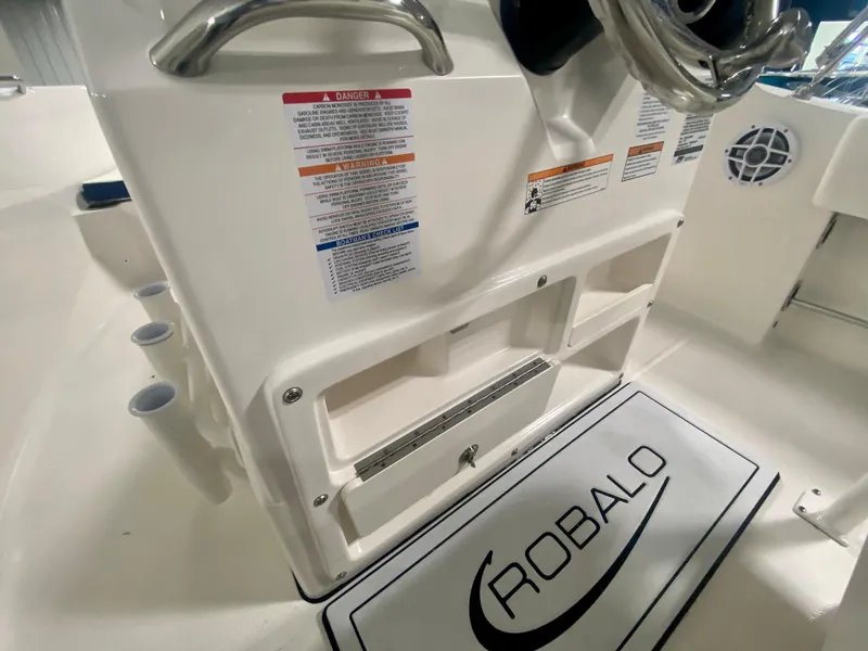Slide: The Image of 2024 Robalo R180 Center Console boat interior with storage compartments and safety labels. - 10