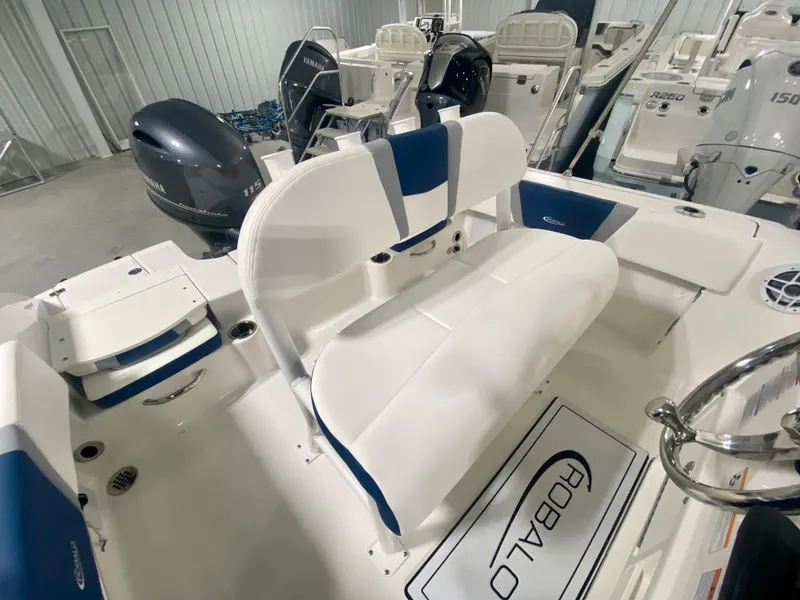 Slide: The Image of 2024 Robalo R180 Center Console boat interior with seating and outboard motors. - 7