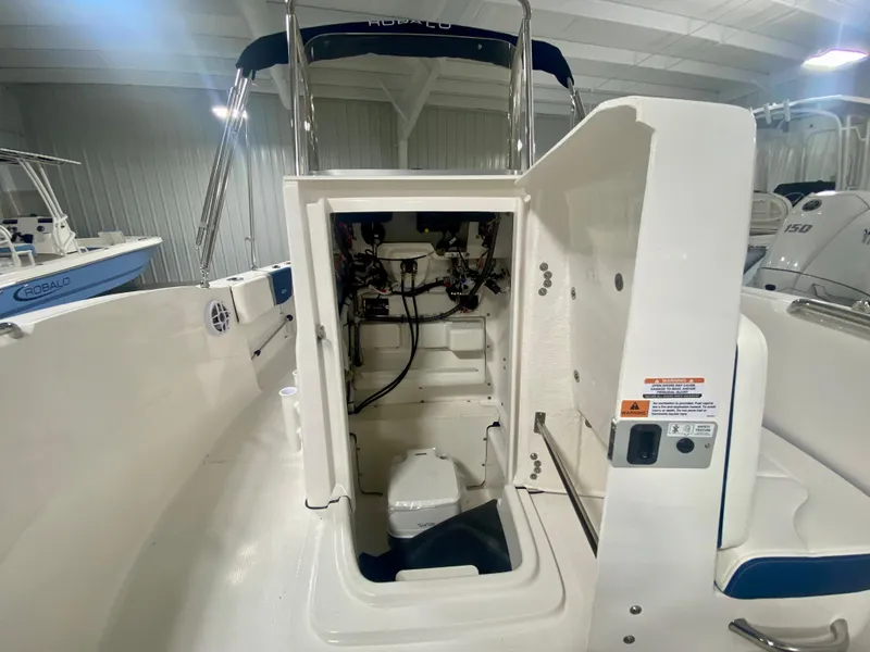 Slide: The Image of 2024 Robalo R180 Center Console boat interior with open storage compartment. - 14