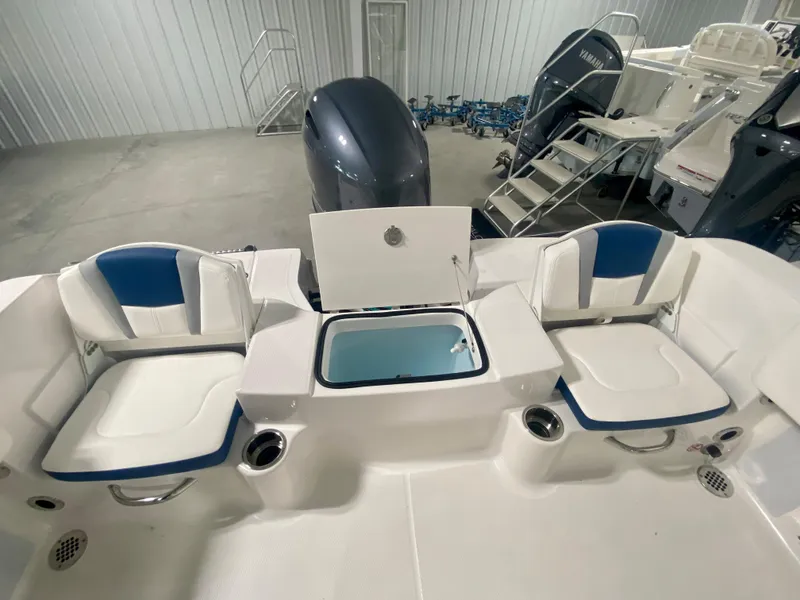 Slide: The Image of 2024 Robalo R180 Center Console boat interior with seating and storage. - 5