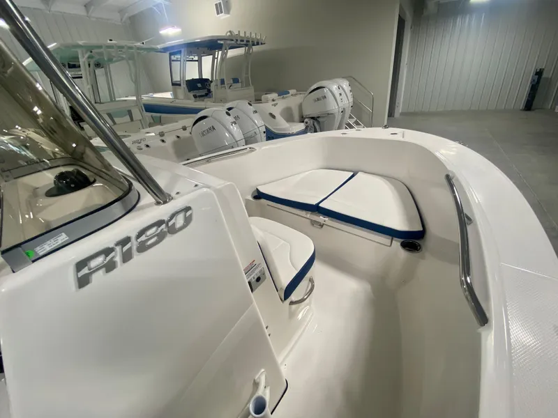 Slide: The Image of 2024 Robalo R180 Center Console boat interior with seating and console. - 11