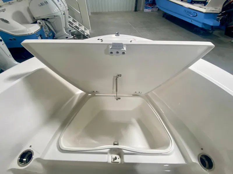 Slide: The Image of 2024 Robalo R180 Center Console storage compartment open. - 17