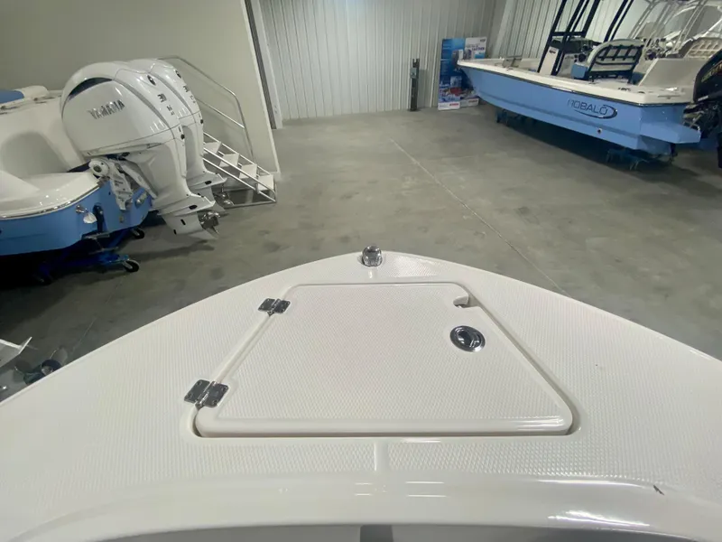Slide: The Image of 2024 Robalo R180 Center Console boat in showroom, front deck view. - 18
