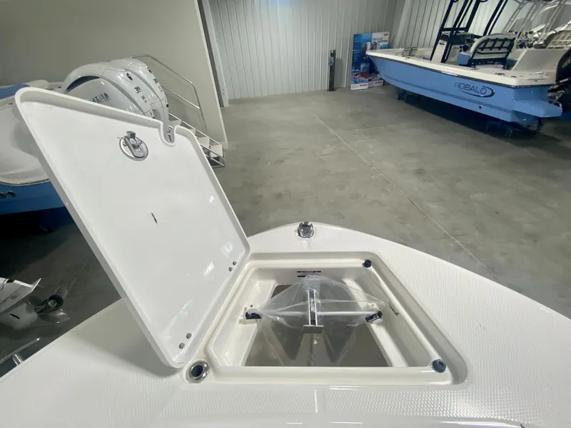 Slide: The Image of 2024 Robalo R180 Center Console boat with open storage compartment. - 19