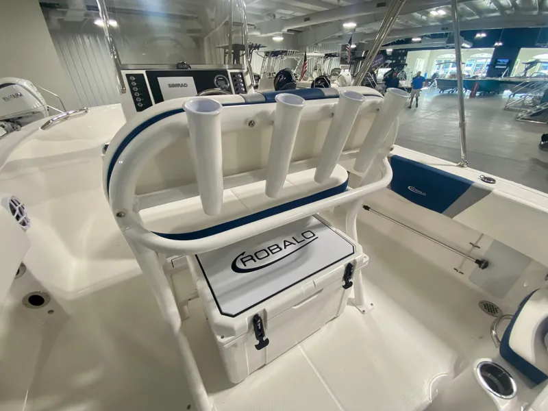 Slide: The Image of 2024 Robalo R180 Center Console boat interior with rod holders and storage. - 6