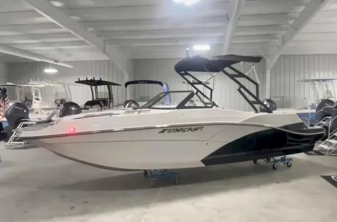 Slide: The Image of 2024 Starcraft SVX 230 OB boat in a showroom. - 0
