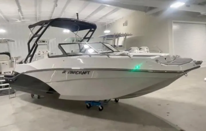 Slide: The Image of 2024 Starcraft SVX 230 OB boat in a showroom. - 1