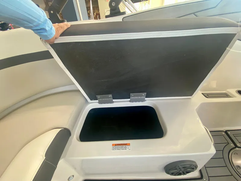 Slide: The Image of 2024 Starcraft SVX 230 OB boat storage compartment with open lid. - 10