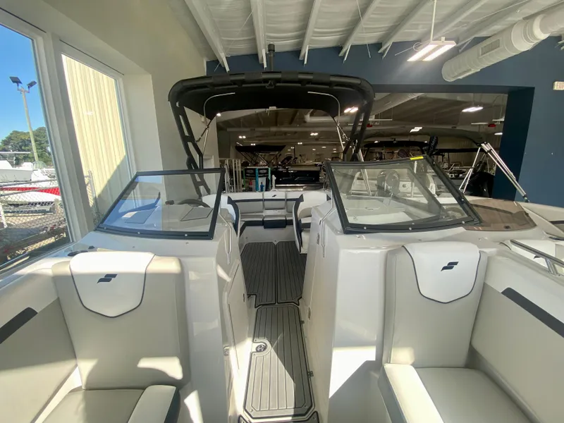 Slide: The Image of 2024 Starcraft SVX 230 OB boat interior with seating and windshield. - 2