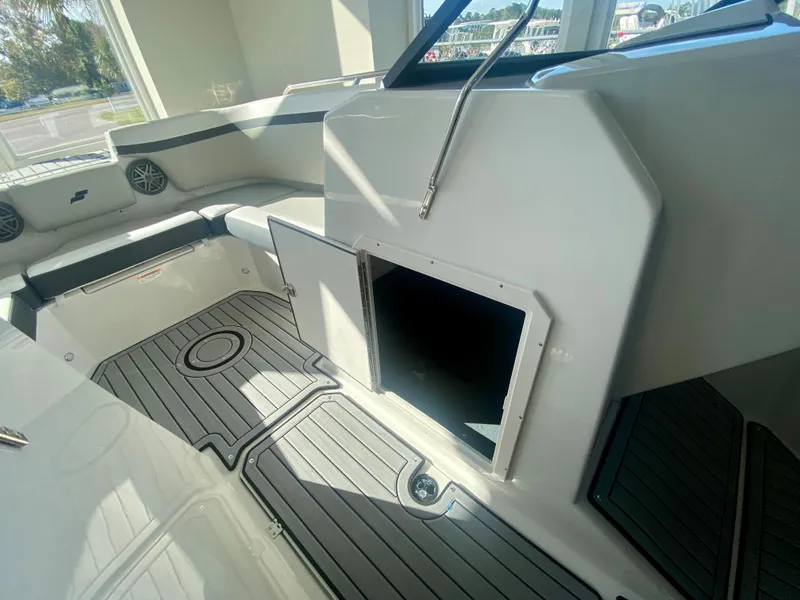 Slide: The Image of 2024 Starcraft SVX 230 OB boat interior with storage compartment and seating. - 20