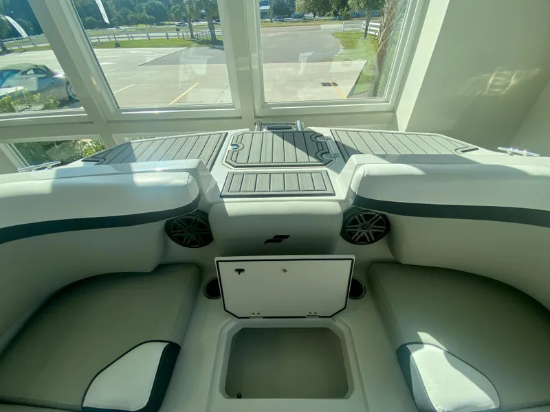 Slide: The Image of 2024 Starcraft SVX 230 OB boat interior with storage compartments and seating. - 28