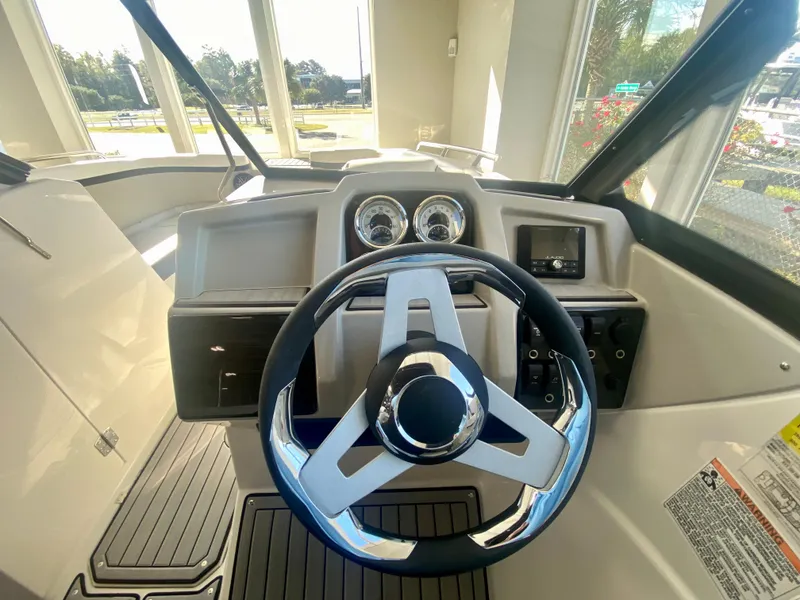 Slide: The Image of 2024 Starcraft SVX 230 OB boat helm with modern steering wheel and dashboard. - 15
