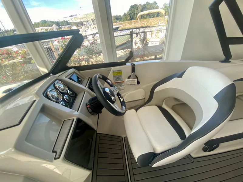 Slide: The Image of 2024 Starcraft SVX 230 OB boat interior with steering wheel and dashboard. - 12