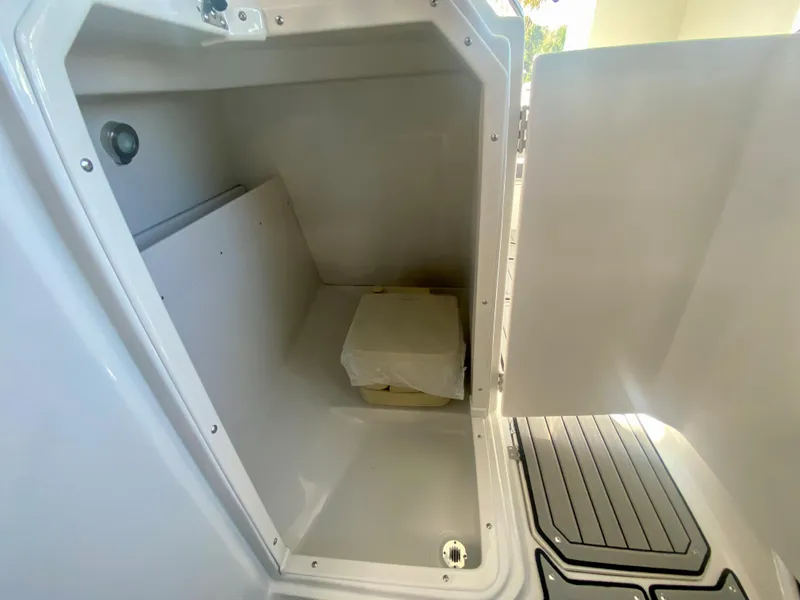 Slide: The Image of 2024 Starcraft SVX 230 OB boat storage compartment with open hatch. - 17
