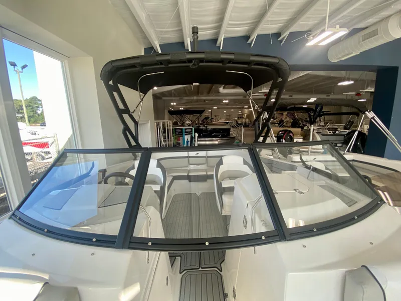 Slide: The Image of 2024 Starcraft SVX 230 OB boat interior with windshield and seating. - 23