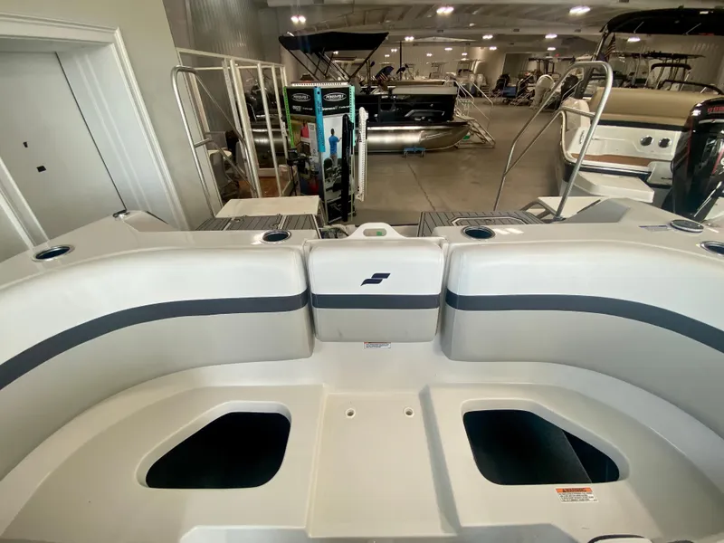 Slide: The Image of 2024 Starcraft SVX 230 OB boat interior at a showroom. - 9