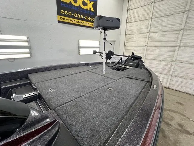 Slide: The Image of 2023 Caymas CX20 Pro boat dashboard with steering wheel and electronic display. - 11