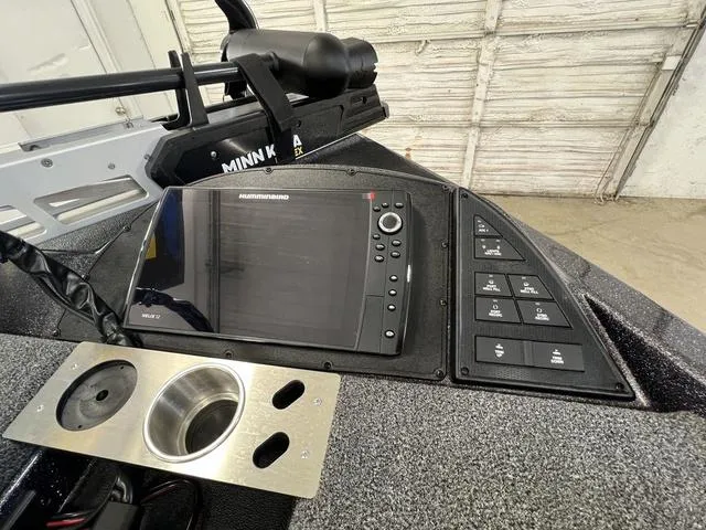 Slide: The Image of 2023 Caymas CX20 Pro boat dashboard with Humminbird electronics and steering wheel. - 12