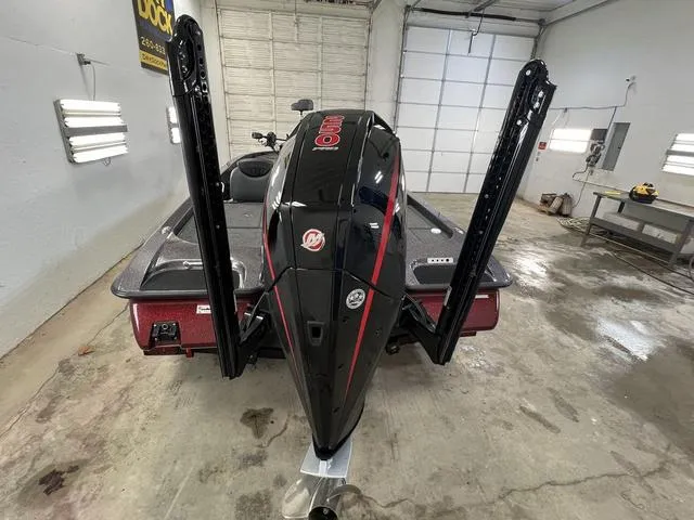 Slide: The Image of 2023 Caymas CX20 Pro boat in garage, rear view with motor and power poles. - 18