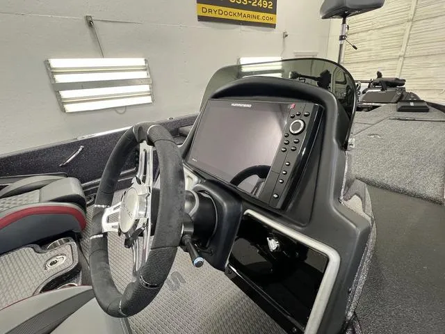 Slide: The Image of 2023 Caymas CX20 Pro boat dashboard with steering wheel and navigation display. - 19