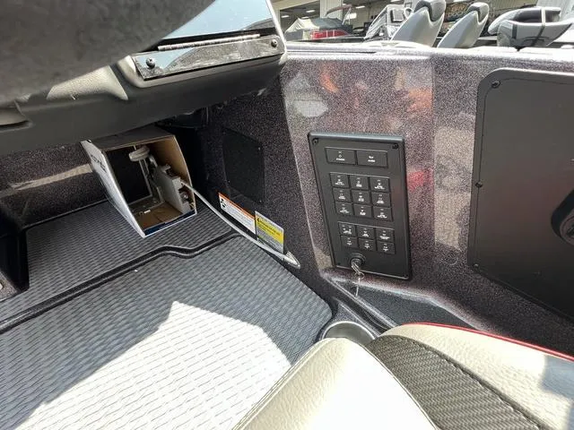 Slide: The Image of 2023 Caymas CX20 Pro boat in a garage, rear view with motor and power poles. - 9