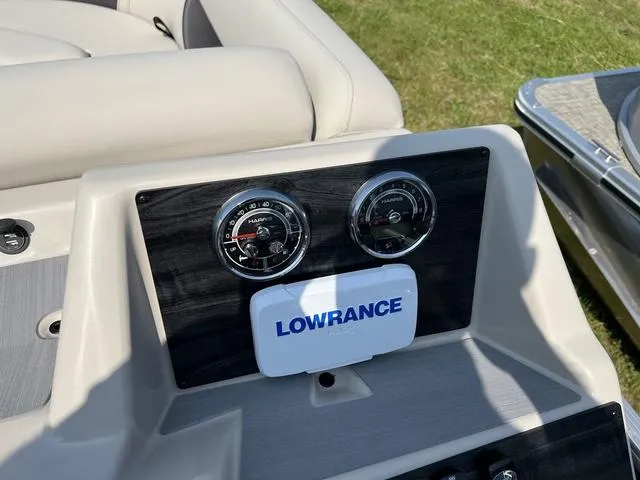 Slide: The Image of 2023 Harris Cruiser 210 CW dashboard with Lowrance electronics and gauges. - 10