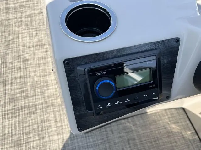 Slide: The Image of 2023 Harris Cruiser 210 CW boat console with Clarion stereo and cup holder. - 13