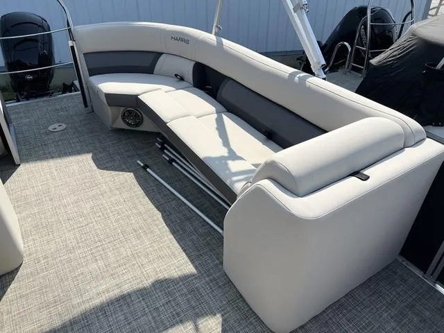 Slide: The Image of 2023 Harris Cruiser 210 CW boat interior with gray seating and carpeted floor. - 14