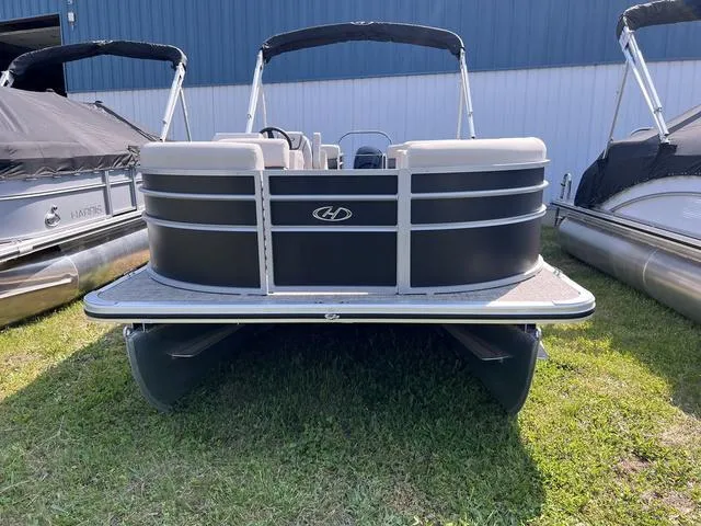 Slide: The Image of 2023 Harris Cruiser 210 CW pontoon boat on grass. - 3