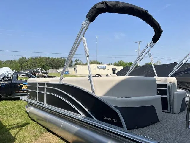 Slide: The Image of 2023 Harris Cruiser 210 CW pontoon boat with black and silver exterior. - 4