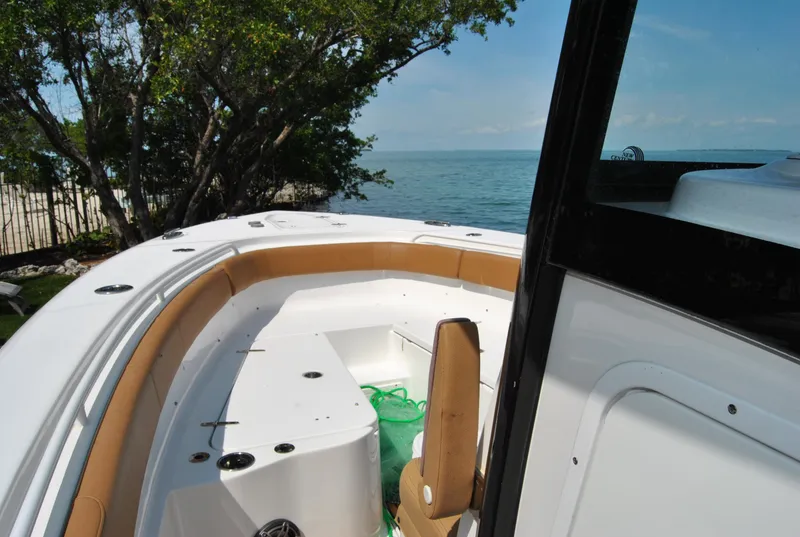 Slide: The Image of 2020 Sea Hunt Gamefish 30 boat interior with ocean view and seating area. - 10