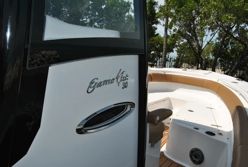Slide: The Image of 2020 Sea Hunt Gamefish 30 boat, sleek design, spacious deck, outdoor setting. - 12