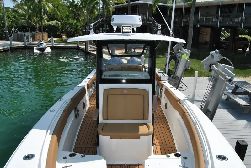Slide: The Image of 2020 Sea Hunt Gamefish 30 boat docked, featuring spacious deck and modern design. - 13