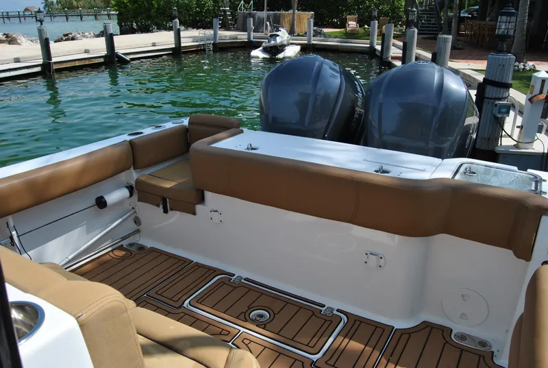 Slide: The Image of 2020 Sea Hunt Gamefish 30 boat interior with twin engines and tan seating. - 15